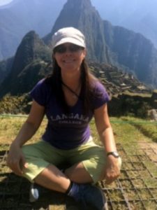 Woman meditating on Machu Picchu